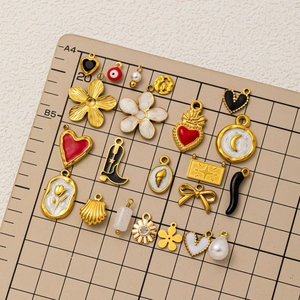 Collection of 19 assorted gold-plated DIY charms with colorful enamel and pearl accents