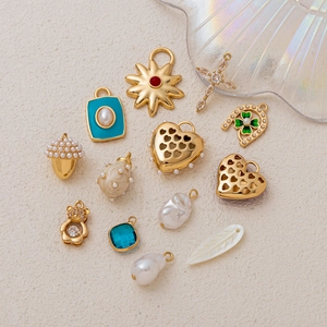 Collection of gold heart pendants, enamel charms and baroque pearls for DIY jewelry making