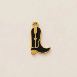 Detail of western boot pendant with black enamel finish and gold hollow star design