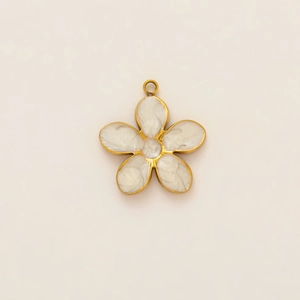 Detailed close-up of a five-petal golden flower charm with white pearlescent inlay