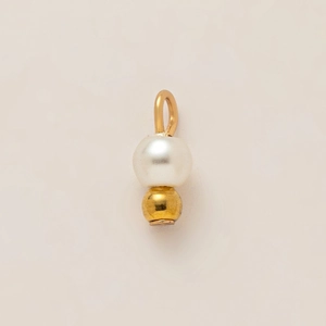 Macro detail of 18K gold plated irregular pendant with round white pearl and metal beads