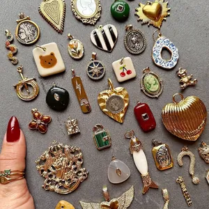 Detailed set of vintage 18K gold plated stainless steel pendants with enamel and gemstones