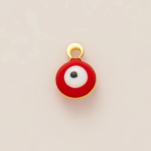 Detailed macro view of the gold-plated red enamel evil eye charm pendant for DIY jewelry