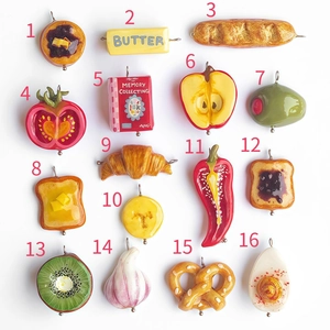 Macro display of 16 miniature food charms including tomato and kiwi with metal rings