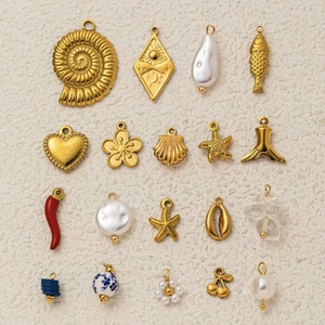 Macro view of 19pcs gold ocean theme charms with sea shells and nautical pendants