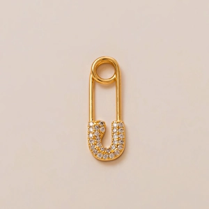 Detailed close-up of gold-plated safety pin jewelry accessory with micro-pave white zircons
