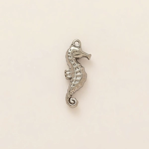 Macro shot of a seahorse pendant made of 18K gold plated stainless steel with scales