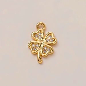 Macro shot of 18K gold plated clover pendant with embedded clear zircon crystals