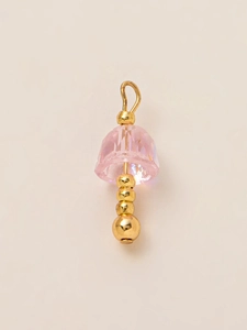 Macro shot of 18K gold plated pendant with pink faceted crystal and tiered gold beads