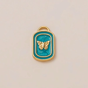 Detail of 18K gold plated rectangular pendant with teal enamel and gold butterfly