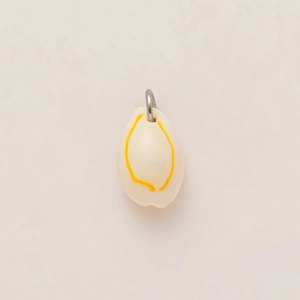 Macro shot of oval shell pendant with yellow rings and a solid gold-plated metal loop