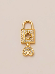 Close-up of 18K gold-plated heart key and lock pendant with micro-pave zircon clover detail