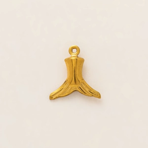 Macro shot of gold-plated whale tail pendant with fine brushed metal texture and ring