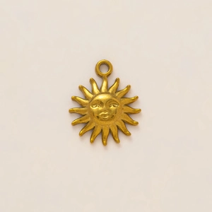 Macro view of vintage gold sunburst face pendant with bohemian style facial relief