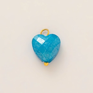 Close-up of heart-shaped blue turquoise pendant with gold vacuum-plated 18k finish