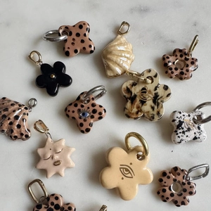 Detailed view of handmade ceramic pendants featuring animal prints and floral patterns