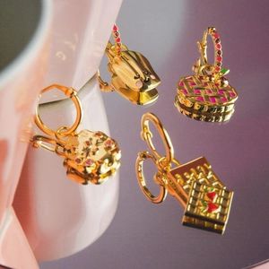 Dettaglio di orecchini placcati oro 14K con ciondoli smaltati colorati animali e frutta