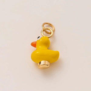 Detail of yellow duckling charm pendant with 18K gold plating and enamel finish
