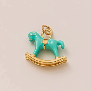 Close-up of a rocking horse pendant with 18K gold plating and turquoise enamel coating