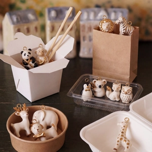 Collection of handmade animal pendants in white ceramic with 14K gold-plated accents