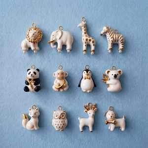 Detailed macro view of 12 animal-themed DIY charms with 14K gold-plated accents