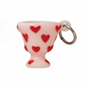 Close-up of cute 18K gold plated pink cup pendant with red hearts and metal ring
