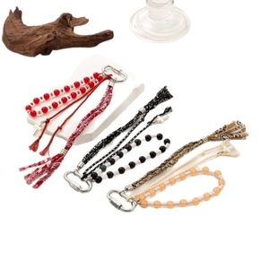 Bohemian DIY keychain charms with colorful beads, ethnic woven straps and tassels on white background