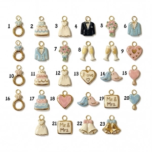 Flat lay of 23 gold 18K plated wedding charms with enamel details for DIY jewelry making