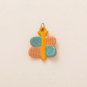 Colorful ceramic butterfly pendant with orange body and patterned wings for DIY jewelry