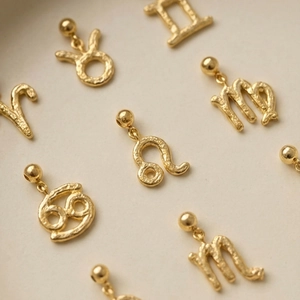 Golden stainless steel zodiac pendants with textured finish and bead clasps for jewelry