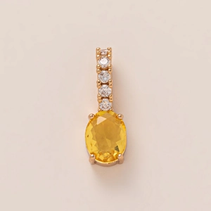 Detail of oval yellow gemstone pendant with rose gold bar and four round white diamonds