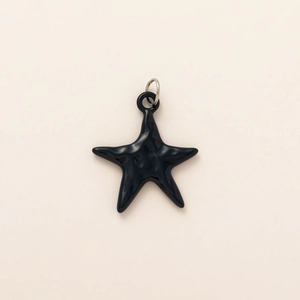 Minimalist black ceramic starfish pendant with polished glaze and silver ring detail