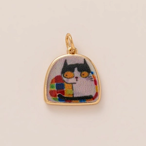 Detailed view of a golden arch pendant featuring a minimalist black and white cat illustration