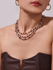 Detailed view of triple-layered necklace with freshwater pearls and colorful stones