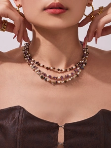 Three-layer necklace with freshwater pearls and natural purple stones on a model