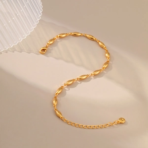 Minimalist gold adjustable bracelet with oval beads and lobster clasp in a warm setting