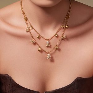 Gold double-layered bead necklace with 5A zircon bear, heart, and bow charm pendants