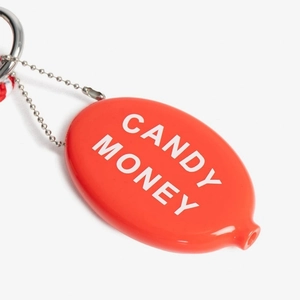 Detail view of red oval squeeze coin purse with silver bead chain and white logo text