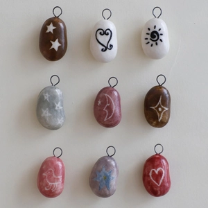 Set of nine hand-painted clay pendants with sun moon star and flower charms for DIY jewelry