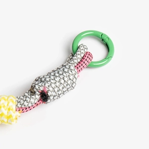 Macro shot of colorful woven rope keychain with green spring gate ring clasp