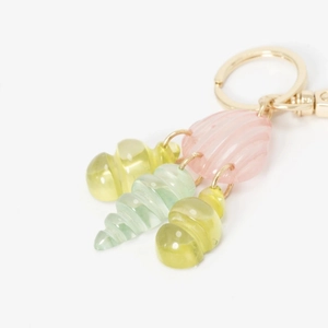 Detailed close-up of a pink resin shell keychain with colorful spiral sea snail pendants