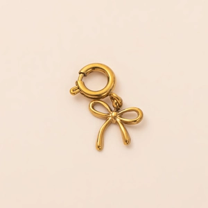 Close-up of a polished 18K gold plated bow pendant with a round spring clasp for DIY jewelry