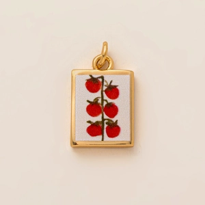 Detailed macro view of 18K gold plated rectangular pendant with red tomato pattern