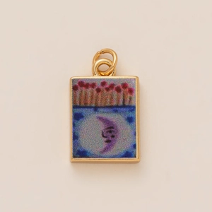 Artistic rectangular pendant detail with golden border and colorful crescent moon motif