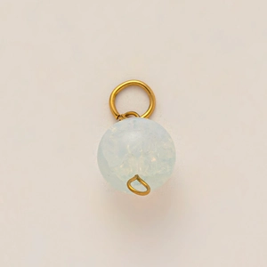 Vue macro d'un pendentif en pierre bleu clair avec des composants dorés à l'or 18 carats
