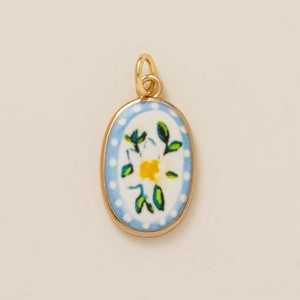 Golden oval flower pendant with white enamel inlay and delicate hand-painted floral motifs