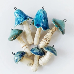Macro view of assorted colorful ceramic mushroom pendants with glossy glazed finish