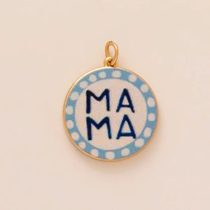 Detail of a round copper pendant with a white base and blue MAMA text and dots