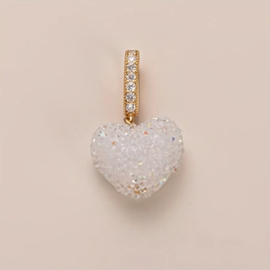 Detail view of heart pendant with gold bail and micro-pave white sparkling zircon