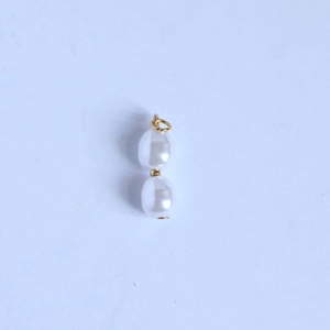 Detail view of double white oval pearls with 18K gold plated stainless steel connectors